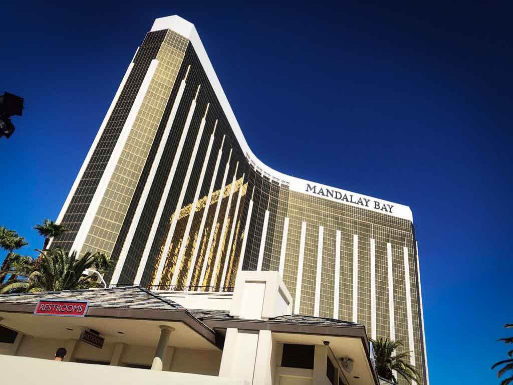 mandalay bay hotel with its tall golden walls against a very blue sky