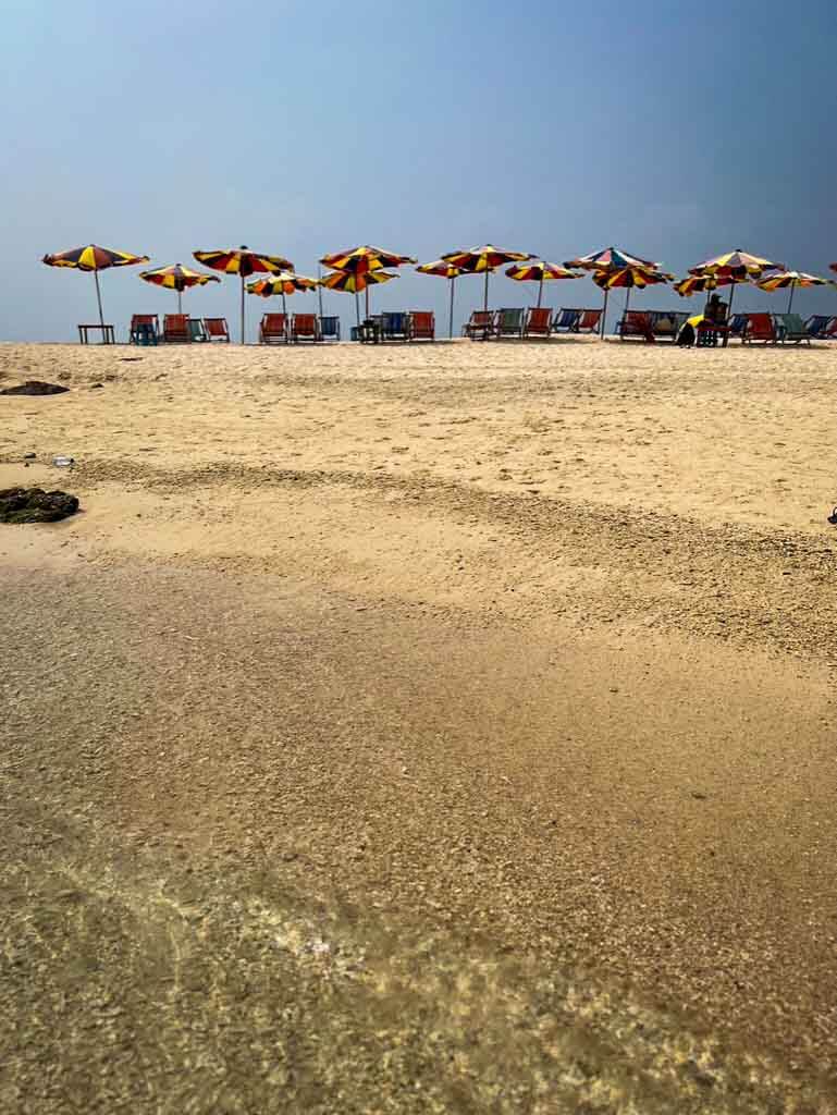 colourful sunbeds on khai Nok island near phuket at the top of a sand dune
