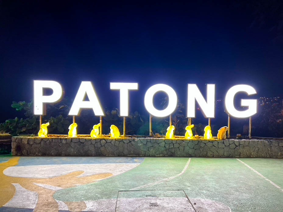 brightly lit sign that says PATONG