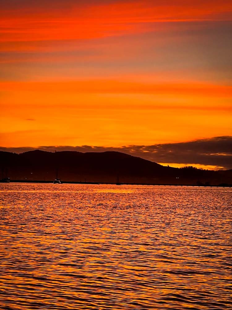 very orange sunset sky above the Knysna Lagoon