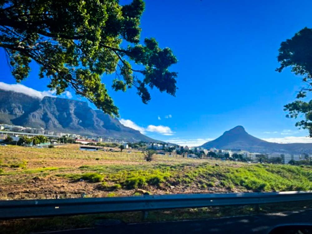 view of lions head and table mountain in front of a blue sky